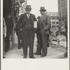 Salvation Army, San Francisco, California. Men pause a moment to watch, and then pass on