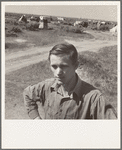 Farm-reared youth with no opportunity on the farm, now travelling single among the migrants. Kern County, California