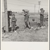 Living conditions for migratory children in private auto camp during pea harvest. Tent space fifty cents a week. Outskirts of Calipatria, California