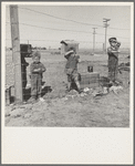 Living conditions for migratory children in private auto camp during pea harvest. Tent space fifty cents a week. Outskirts of Calipatria, California