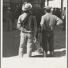 Outside the Farm Security Administration (FSA) grant office during the pea harvest. Calipatria, California. During spring of 1938 for the first time, the labor surplus had grown so large that relief grants were necessary even during the peak of harvest. Colored migrants are becoming more numerous this year