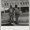 Calipatria. Idle pea pickers come into town and discuss prospects for work on the street corners