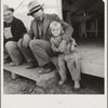 Farm Security Administration (FSA) migratory labor camp. Brawley, California. Father is home after a day in the pea fields. Note tent platform, standard equipment in Farm Security Administration camps