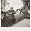 Migrant family from Arkansas playing hill-billy songs. Farm Security Administration emergency migratory camp. Calipatria, California