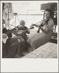Migrant family from Arkansas playing hill-billy songs. Farm Security Administration emergency migratory camp. Calipatria, California