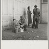 Outside the Farm Security Administration (FSA) grant office during pea harvest. Calipatria, California. During the spring of 1938 for the first time the labor surplus has grown so large that relief grants were necessary even during the peak of harvest