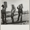 Pea pickers coming in from field to the weigh master. Imperial Valley, California