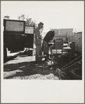 In a carrot puller' camp near Holtville, Imperial Valley, California. Migratory laborers from Texas, packing up to leave camp because of work shortage. "Don't take any pictures of us. We don't want any truck with Mr. Hearst"