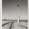 Looking east down the railroad track, near Calipatria, California. Single men, itinerants with "bindles" waiting for the freight