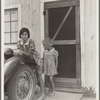 Greenfield, Salinas Valley, California. An Arkansawyers auto camp filled almost completely with migrants from Arkansas. Rent ten dollars a month for one room, iron bed, electricity. Rough board walls with cracks