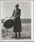 A grandmother in a contractor's camp. Stanislaus County, California. "Been in California fourteen months from Oklahoma. The main thing is to get our families located and quieted down. Ain't no use to send them back; it's a waste of money. They won't stay."