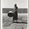 A grandmother in a migrant camp. Stanislaus County, California. "Been in California fourteen months. From Oklahoma. The main thing is to get our families located and quieted down. Ain't no use to send them back; it's a waste of money. They won't stay."