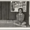 Advertisement for current movie in town. The child is a flood refugee of March 1938 from southeast Missouri. Westley, California