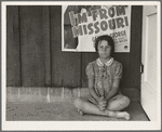 Advertisement for current movie in town. The child is a flood refugee of March 1938 from southeast Missouri. Westley, California