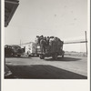 Labor contractor's truck with gang of pea pickers, pulled up for gas. Near Westley, California