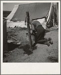 A grandmother washing clothes in California. In a contractor's camp near Westley, California