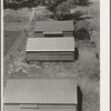 Farm Security Administration (FSA) camp for migratory agricultural workers. Farmersville, California. Shows prefabricated steel shelters which have been erected to replace tents as standard camp equipment in two of the California camps