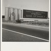 Between Tulare and Fresno on U.S. 99. Highway gas tanks and signboard approaching town. See general caption