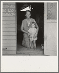 Tulare County, Farm Security Administration (FSA) camp. Migrant mother and child at doorway of steel shelter