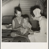 Farm Security Administration (FSA) camp. Farmersville, California. Resident nurse interviews mother and examines sick baby