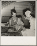 Farm Security Administration (FSA) camp. Farmersville, California. Resident nurse interviews mother and examines sick baby