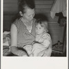 Farm Security Administration (FSA) camp at Farmersville, California. Mother from Oklahoma, migrant, awaits visit of resident nurse for sick baby