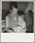 Farm Security Administration (FSA) camp at Farmersville, California. Mother from Oklahoma, migrant, awaits visit of resident nurse for sick baby