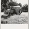 Between Tulare and Fresno on U.S. 99. See general caption. Family inspect a house trailer with idea of purchase