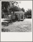 Between Tulare and Fresno on U.S. 99. See general caption. Family inspect a house trailer with idea of purchase