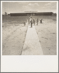 Farm Security Administration (FSA) camp at Farmersville. Nursery school children showing community laundry building. California