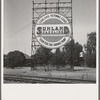 Outskirts of Fresno. On U.S. 99. Illuminated sign, approaching San Joaquin Valley town. See general caption. California