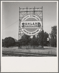Outskirts of Fresno. On U.S. 99. Illuminated sign, approaching San Joaquin Valley town. See general caption. California