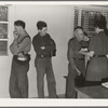 Tulare County, California. Camp for migratory agricultural workers at Farmersville. Sons, migratory workers, bring father, who is sick and old to the camp clinic