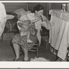 Tulare County, California. In Farm Security Administration (FSA) camp. Mother from Oklahoma tends baby with dysentery and awaits arrival of FSA camp resident nurse