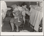 Tulare County, California. In Farm Security Administration (FSA) camp. Mother from Oklahoma tends baby with dysentery and awaits arrival of FSA camp resident nurse