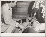 Tulare County, California. Farm Security Administration (FSA) camp for migratory agricultural workers at Farmersville. Nurse of Agricultural Workers' Health and Medical Association attends sick migrant woman while awaiting doctor