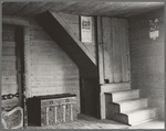 Corner of tobacco farmer's front room. Shows enclosed stairway and corner of the new fancy bed. Person County, North Carolina