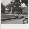 Men idling around the courthouse square. Note Confederate monument characteristic of Southern towns. Roxboro, North Carolina