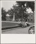 Men idling around the courthouse square. Note Confederate monument characteristic of Southern towns. Roxboro, North Carolina