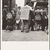 42nd Street and Madison Avenue. Street hawker selling Consumer's Bureau Guide. New York City