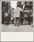 42nd Street and Madison Avenue. Street hawker selling Consumer's Bureau Guide. New York City