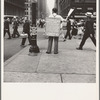 42nd Street and Madison Avenue. Street hawker selling Consumer's Bureau Guide. New York City