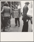 42nd Street and Madison Avenue. Street hawker selling Consumer's Bureau Guide. New York City