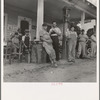 Fourth of July, near Chapel Hill, North Carolina. Rural filling stations become community centers and general loafing grounds. The men in the baseball suits are on a local team which will play a game nearby. They are called the Cedargrove Team