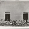 Women of the congregation of Wheeley's Church on steps with brooms and buckets on annual clean up day. Gordonton, North Carolina