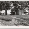 The one-and-a-half story part of this house was built fifty to sixty years ago. The two-story part was built in 1900. Farm is owned by a woman whose husband died seventeen years ago. Person County, North Carolina