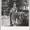 Wife of tenant farmer, Mrs. Oakley, works stringing tobacco during the harvest season. Granville County, North Carolina