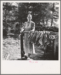 Wife of tenant farmer, Mrs. Oakley, works stringing tobacco during the harvest season. Granville County, North Carolina