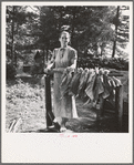 Wife of tenant farmer, Mrs. Oakley, works stringing tobacco during the harvest season. Granville County, North Carolina