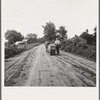 Mr. Taylor and wage laborer slide the tobacco to barn from the field, about quarter of a mile. Granville County, North Carolina